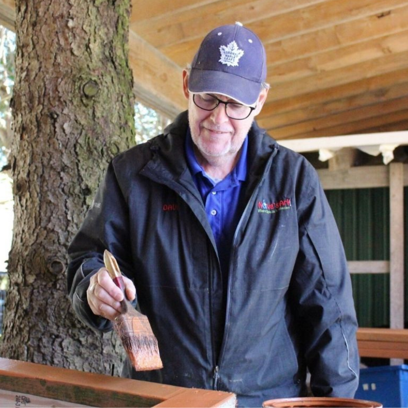 Dave painting wood.
